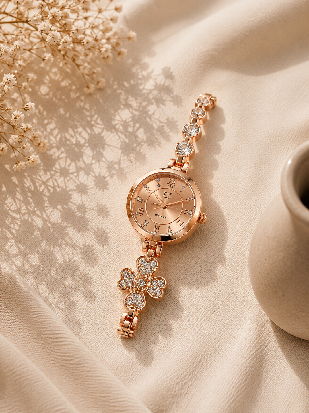 Product Details Product Type: Women's Luxury Jewelry Watch Color: Rose Gold Display Type: Analog Movement: Quartz Dial Design: Sunray Rose Gold Dial Hour Markers: Roman Numerals & Crystal Indexes Bracelet Style: Crystal Embellished Bracelet Design Feature: Floral Crystal Charm Detail Style: Luxury, Elegant & Feminine Occasion: Daily Wear, Parties, Formal Events & Gifting